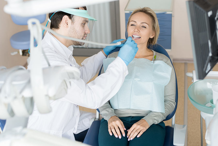 man-working-with-ill-tooth-of-client-Y9XRJPB.jpg